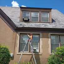 Painter completing exterior trim work