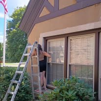 Painter working on exterior architectural details